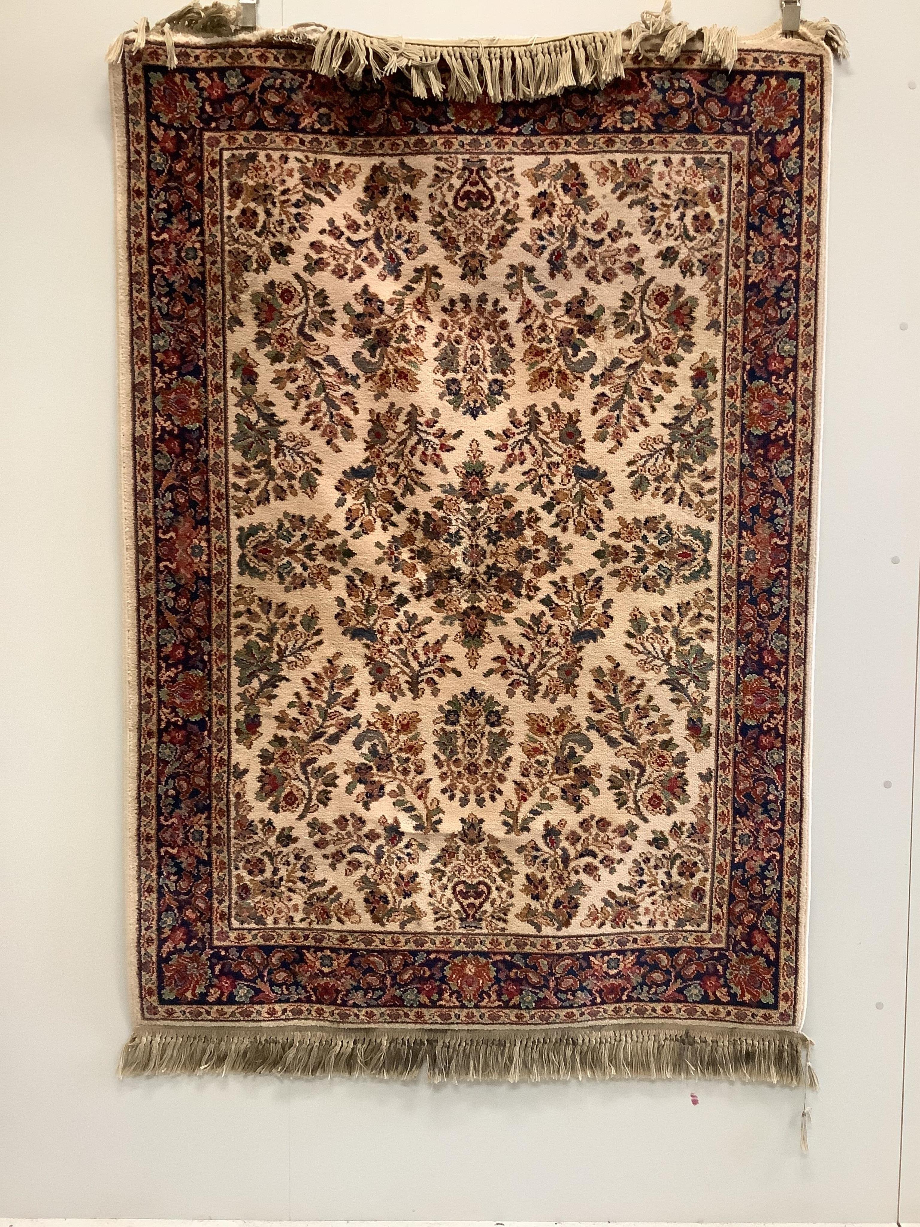 A Karastan Sarouk style ivory ground rug, 190 x 133cm. Condition - fair